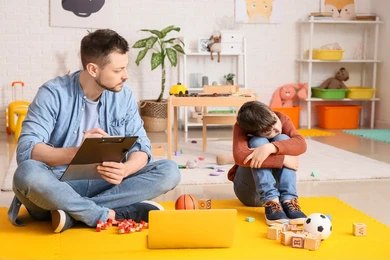A diverse group of children and adults with Autism Spectrum Disorder smiling and interacting